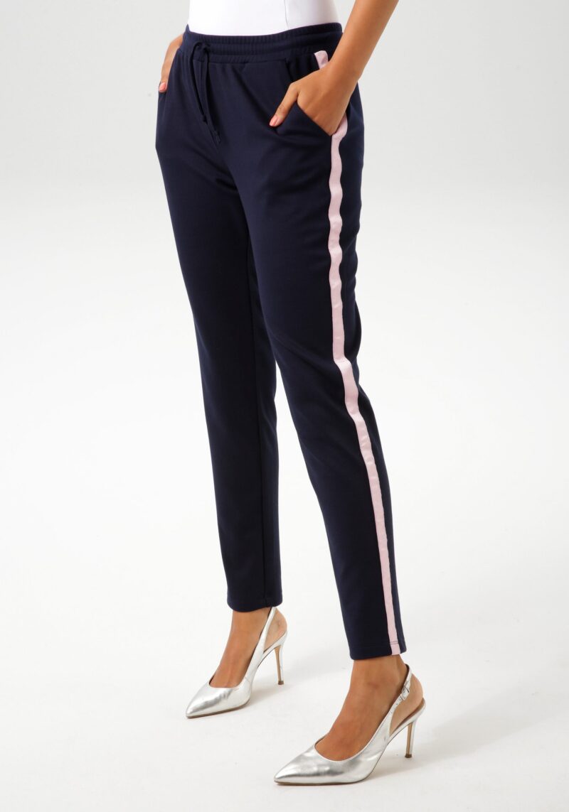 Pull-on trousers with pink tape on the side seams